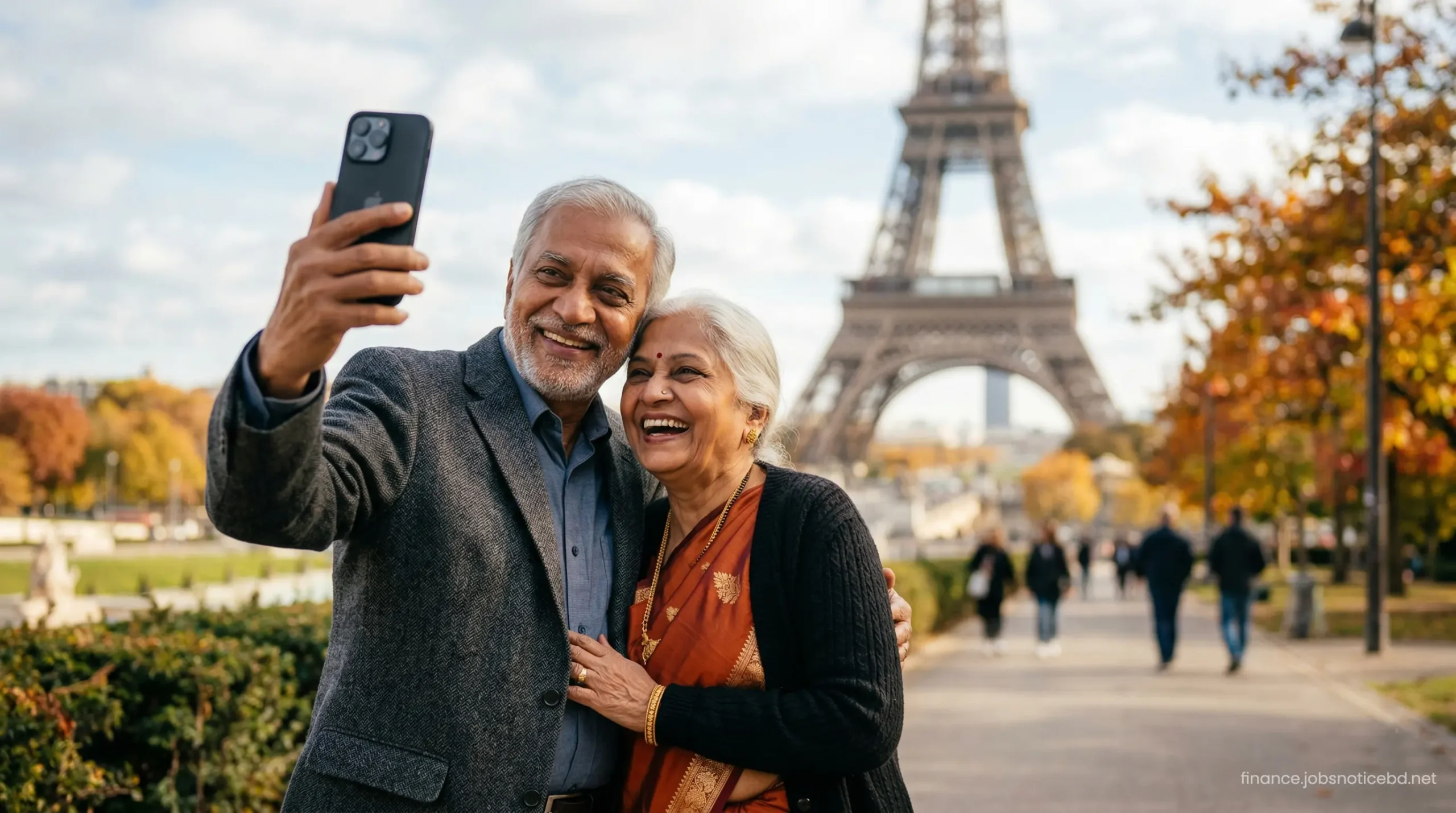 A happy elderly Indian couple enjoying a luxury vacation near the Eiffel Tower in Paris.
