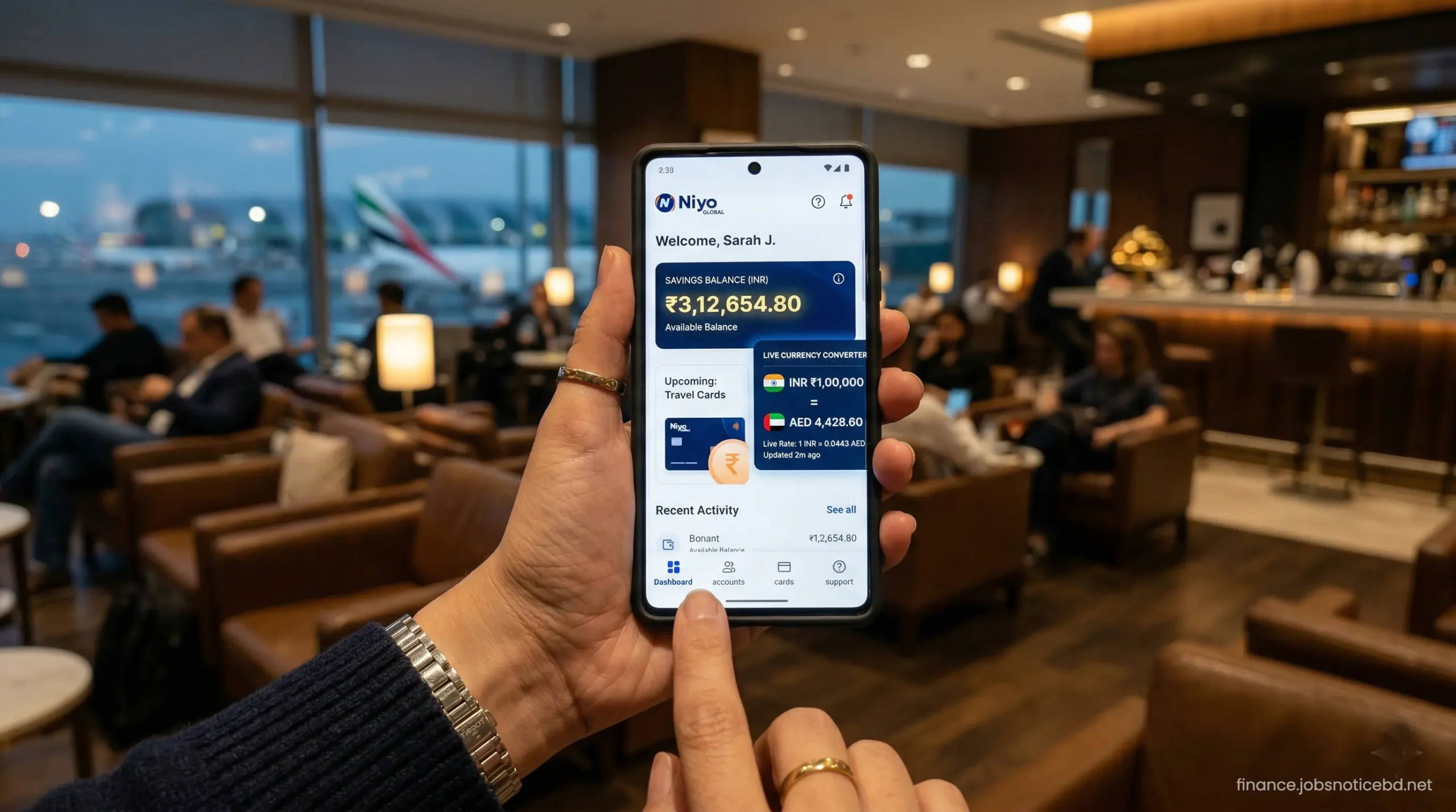 A close-up of a smartphone screen displaying the Niyo Global mobile banking application dashboard and currency converter.